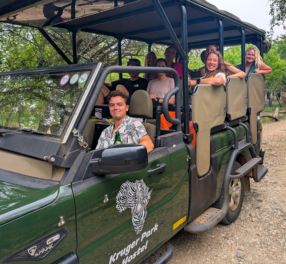 Guests in the open safari vehicle preparing to go for their bush walk culmination with dinner at the Crocodile River overlooking the Kruger National Park.