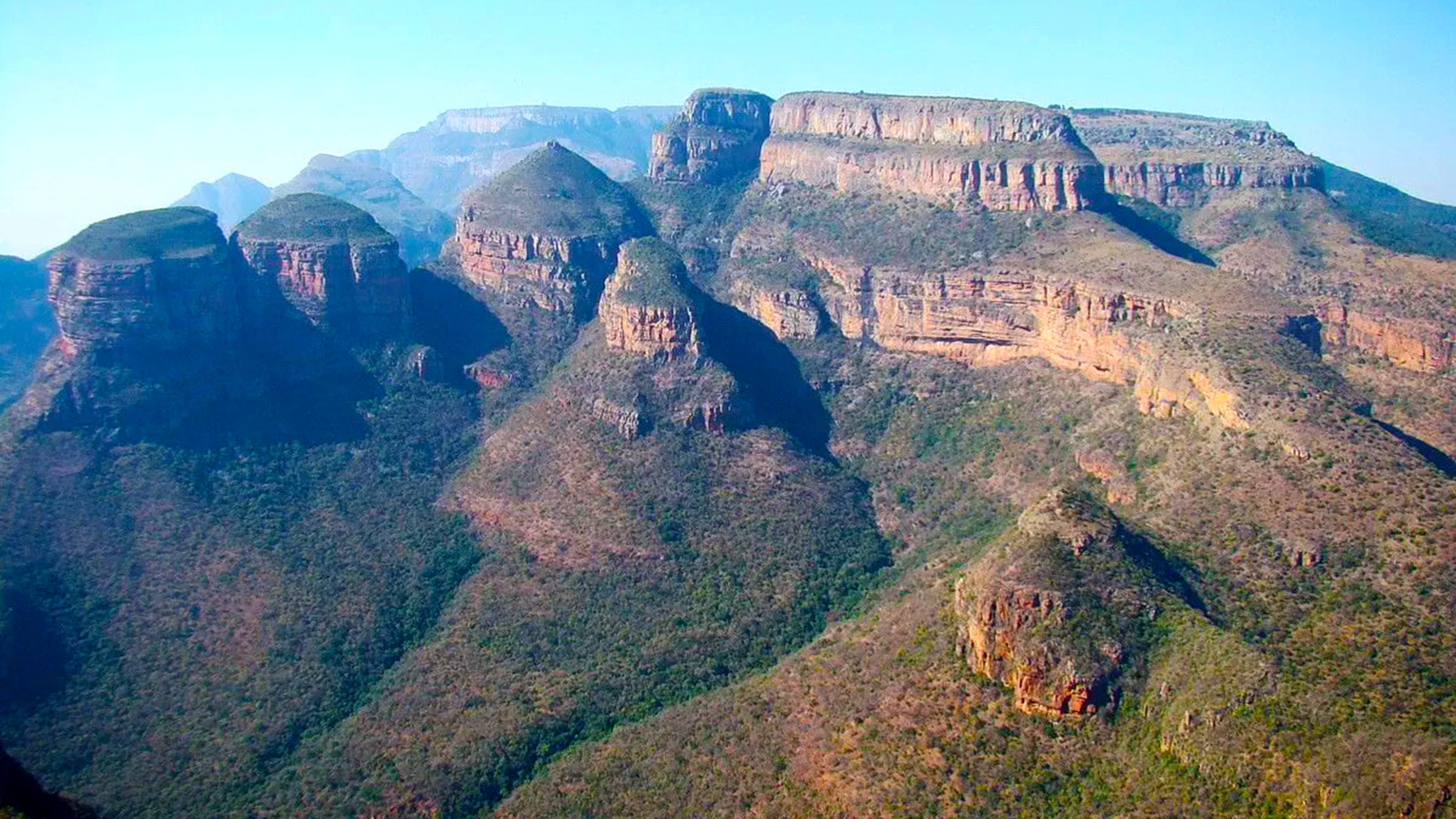 The Three Rondavels overlooking Blyde River Canyon on South Africa's Panorama Route in Mpumalanga, with dramatic cliffs, lush green canyon walls, and expansive scenic views.