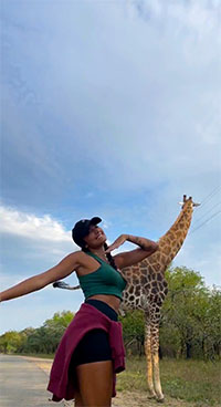 Guests waling up to a Giraffe in Marloth Park Game Reserve